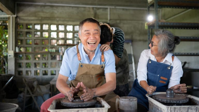 happy older couple using pottery wheels, tms therapy for depression