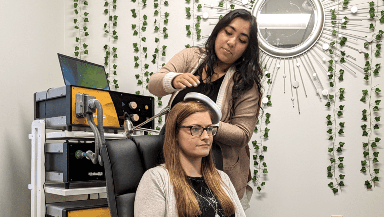 transcranial magnetic stimulation near me, tms technician gently placing tms coil on patients head