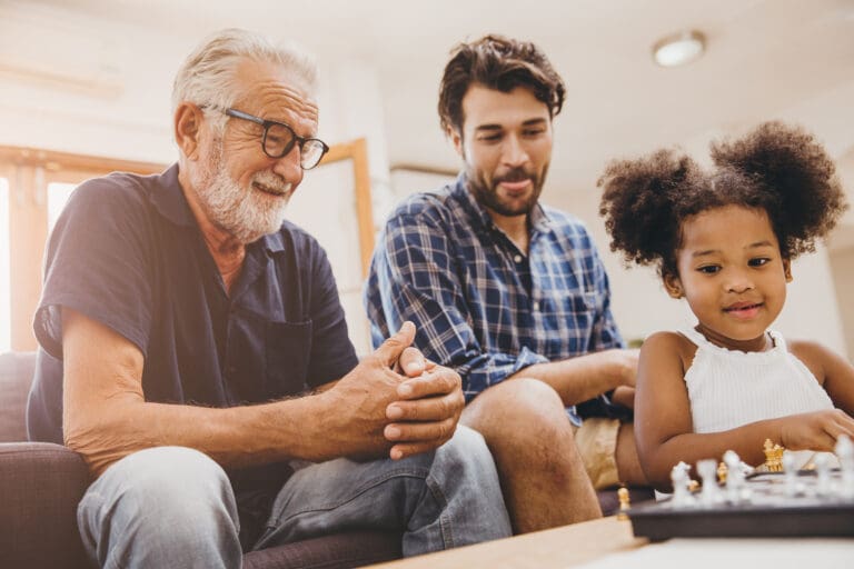 happy man sitting with son and granddaughter after trying psychedelic assisted therapy after wife's death